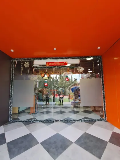 The glass doors to our facility are decorated with a "Merry Christmas" sign and festive trim.