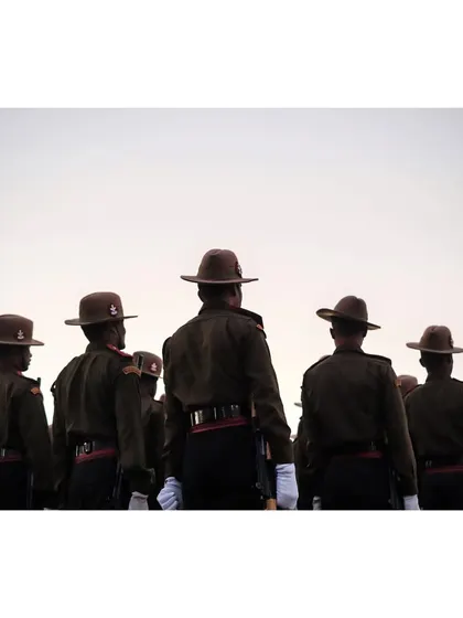 A view from behind the soldiers, showing their disciplined formation and uniforms.