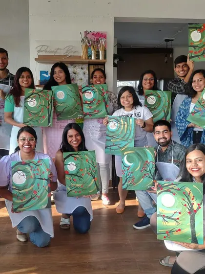 A group of happy painters showing off their finished paintings from our gold leaf open house. So much shine, so much talent.