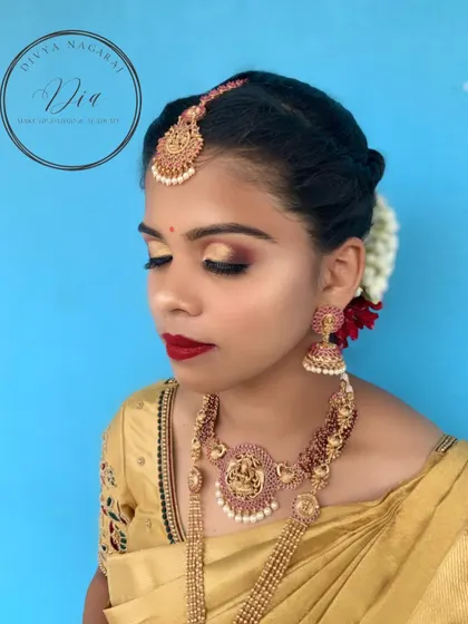 A close-up on the eye makeup for this look. I used a blend of gold and bronze eyeshadows with sharp winged liner to create a dramatic, festive look, paired with a bold red lipstick for that perfect bridal finish.