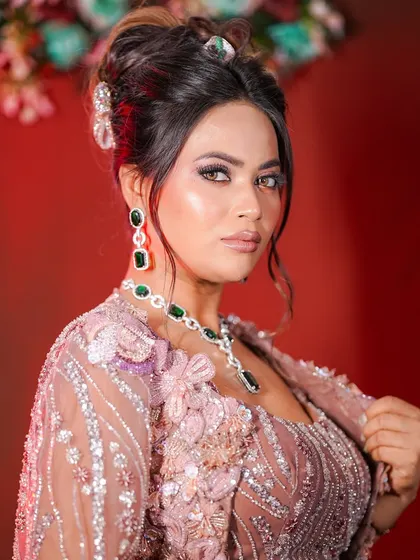 This look is all about elegance. The soft smokey eye, nude lip, and chic updo make for a timeless party look.