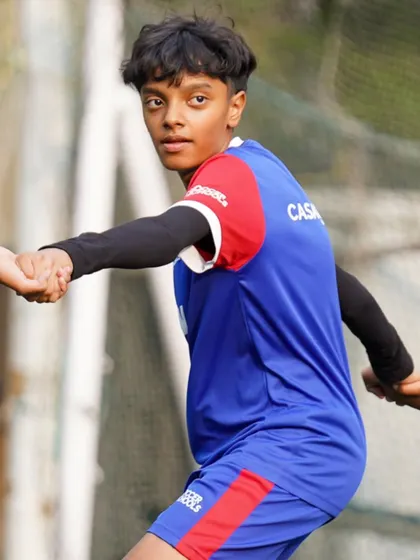 A player looks on with a smile, enjoying the camaraderie of the training session.