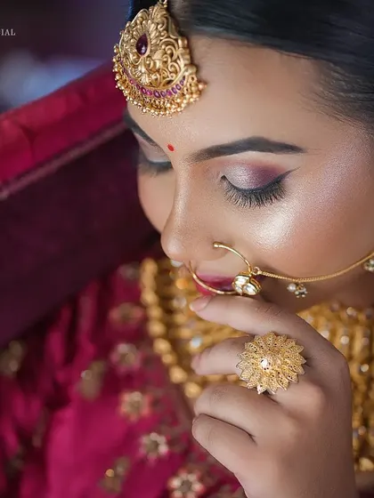 This artistic shot highlights the details of the nath and the soft, shimmery eyeshadow. It's a perfect example of a glamorous yet traditional bridal look.