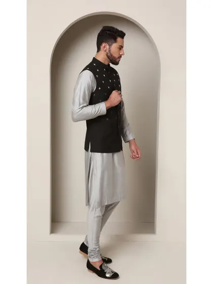 A side view of the 'Shoorveer' set, highlighting the contrast between the black jacket and the light grey kurta. The clean lines and perfect fit are evident from this angle.