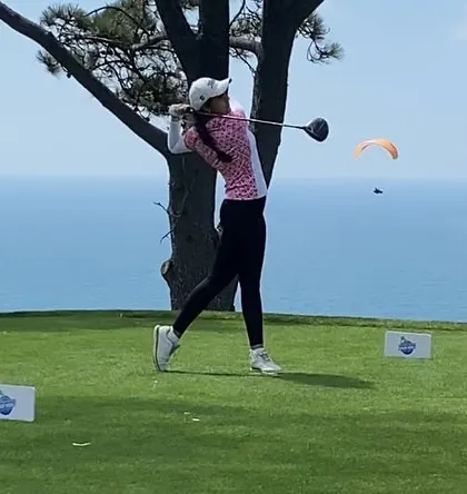 A powerful shot of Mahreen Bhatia executing a drive with a stunning ocean backdrop at the Torrey Pines South Course. She achieved a Tied-6th finish at the USwing Mojing Junior World Golf Championships.