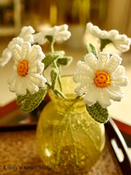 Just a bunch of daisies, bringing their simple, friendly charm to a yellow vase.