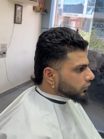 A client with a curly mullet. I work with the hair's natural texture to create a unique and personalized version of this popular style.