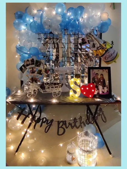 A full view of our in-house birthday decor. This setup includes a balloon arch, a shimmer wall for photos, a personalized dessert table, and fairy lights to make the space feel festive and special.