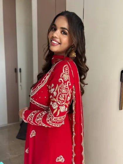 Simple glam and happy vibes. This look is all about glossy nude lips and glowing skin, paired with a vibrant red outfit for a fresh and modern festive style.