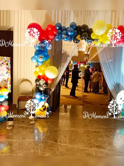 The entrance to the music party, featuring a colorful balloon arch, a welcome sign, and a guitar prop to set the tone.