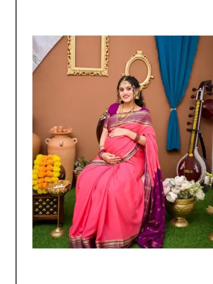 A serene portrait of a mom-to-be in a beautiful pink and purple saree. The setting is adorned with traditional elements like clay pots, marigold flowers, and a veena, creating a peaceful and culturally rich atmosphere for this maternity session.