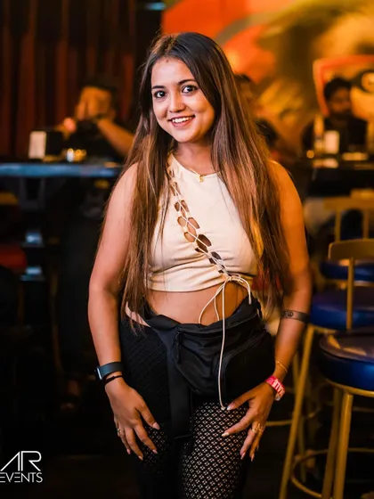 A stylish guest posing at the bar.