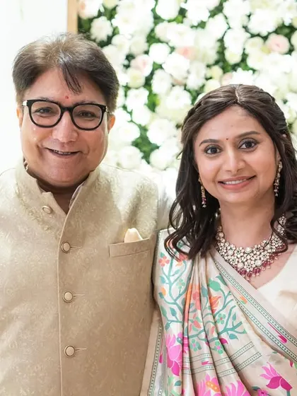 A classic portrait of the happy parents. Her makeup is timeless and enhances her natural grace.
