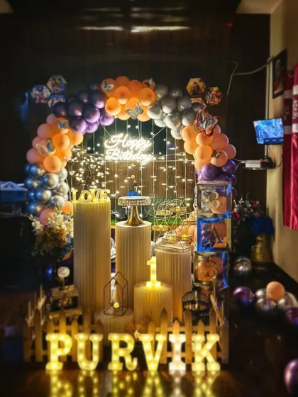 A birthday setup with a unique color combination of orange, purple, and silver balloons, showing my ability to work with any custom color palette.