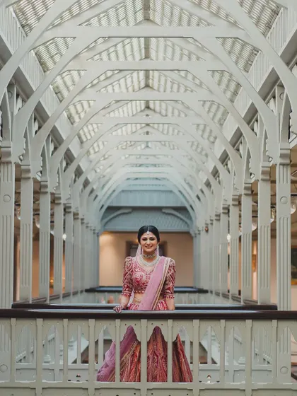 This architectural shot frames the bride beautifully, showcasing her as a work of art. Her elegant makeup and posture exude pure grace.
