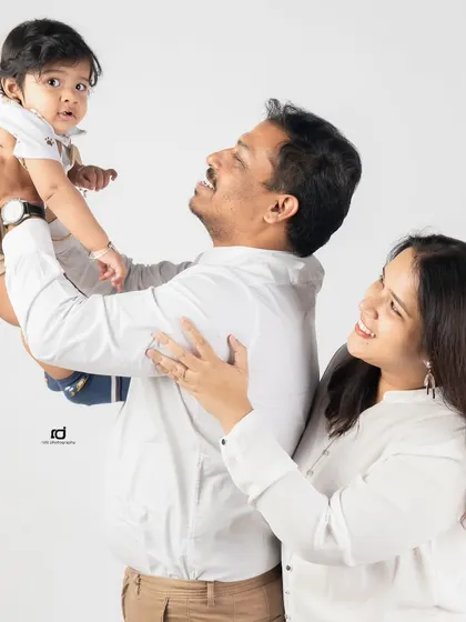 Up in the air! A father lifts his son, and the joy on everyone's faces is contagious. I love capturing these active, happy moments during a family session.