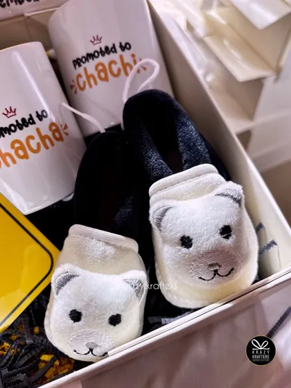Adorable fuzzy bear-themed booties paired with "Promoted to Chacha & Chachi" mugs make for a super cute and exciting pregnancy reveal gift.