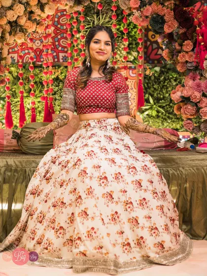 The bride, Saumya, looking beautiful and serene at her Mehendi ceremony, with intricate henna designs on her hands.