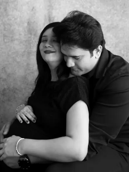A tender moment of the father-to-be embracing his partner from behind. This black and white image is full of emotion and love.