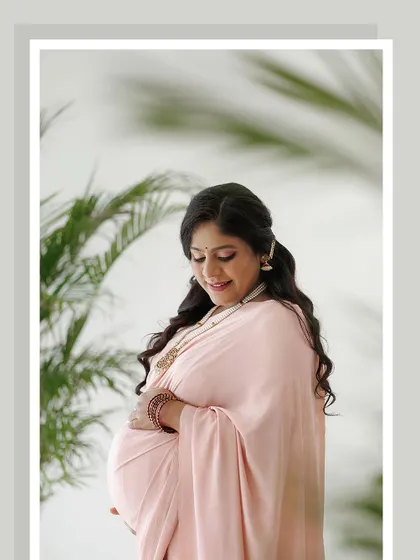 A beautifully framed shot highlighting the client's serene expression. The soft pink tones in her makeup and the elegant hairstyle create a cohesive and polished look.