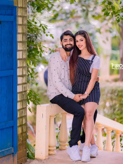 A sweet, coordinated look with the couple on a balcony. Their casual outfits and their close pose make for a very intimate and romantic portrait.