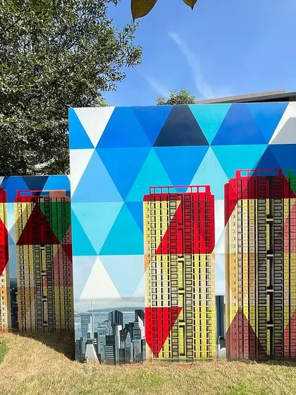 The geometric patterns and cityscape elements of the Sobha mural create a stunning visual effect. This section showcases the fusion of abstract design and realistic urban landscapes.