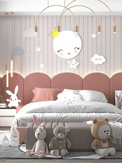 A dreamy pink and white bedroom perfect for a little one. The design features a cloud and star theme, with a cute moon-shaped light and plush toys creating a magical atmosphere.