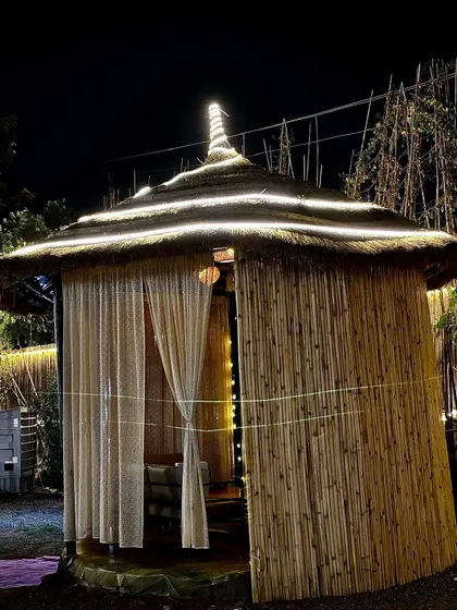 A cozy bamboo hut, perfect for a small group of friends to catch up.