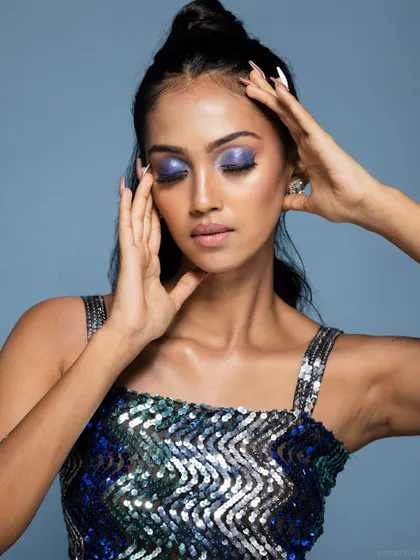 An emotive beauty shot, with the model's eyes closed, focusing on the purple eyeshadow.