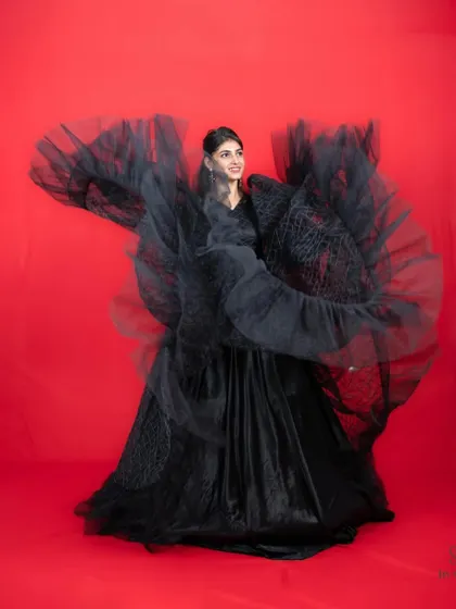 The motion blur captures the beautiful movement of this black gown with dramatic sleeves.
