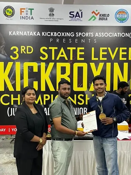 Here I am receiving an award on behalf of the academy at the state kickboxing championship. This is a win for our entire team.