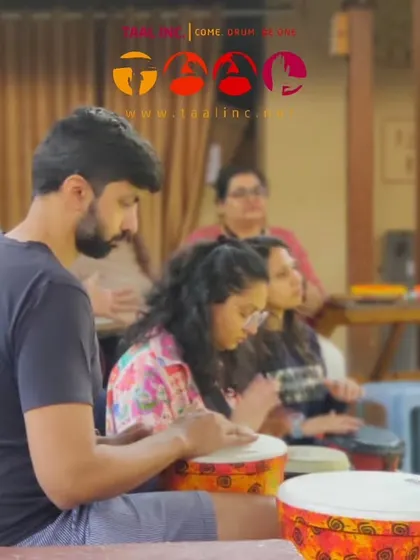 Participants focused on their drumming during a community session. The concentration is intense, but it's a meditative focus that helps to quiet the mind and be fully present.