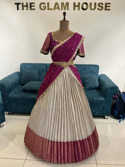 The full view of the silver and magenta half saree, showcasing its pleated skirt and rich colors.