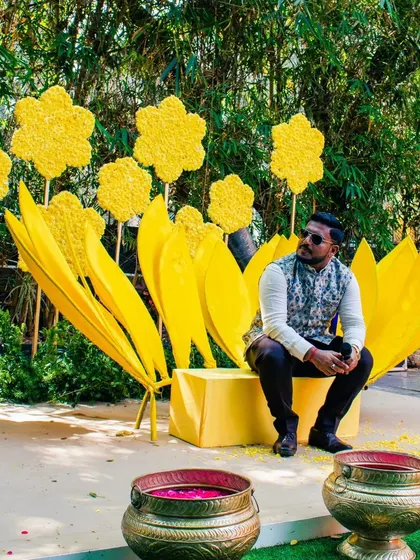 A thoughtful pose amidst the beautiful Haldi decor.