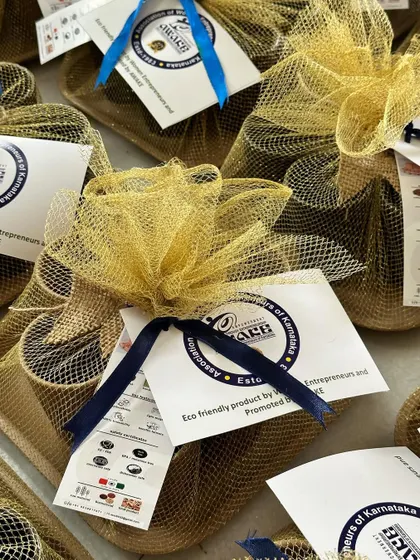 A close-up of the AWAKE branded gift set, wrapped in gold net with a custom tag detailing the eco-friendly products inside.