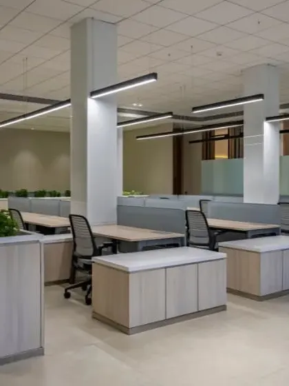Natural light from the large windows fills this workspace. The layout is designed to maximize light for all employees, which is proven to boost morale and productivity.