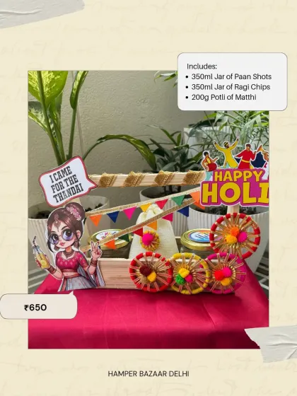 Our Festive Delight Holi Hamper, priced at ₹650, offers a more gourmet experience on a budget. It includes jars of paan shots and ragi chips, along with a potli of matthi.