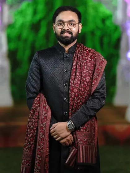 A close up of our black quilted Jodhpuri suit, paired perfectly with a traditional printed shawl. This outfit is a great choice for wedding guests who want a classic yet stylish look. The fit and fabric feel premium.