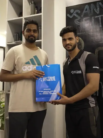 Another milestone celebration. A trainer presents a loyal member with a gift to mark his anniversary with our gym.