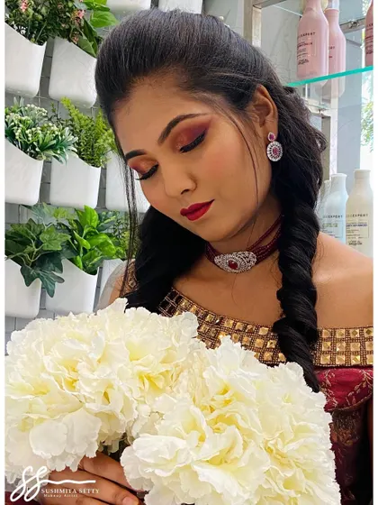 Holding a bouquet, this pose adds a touch of softness to the bold Sangeet look, showing its versatility for different photo opportunities during the event.