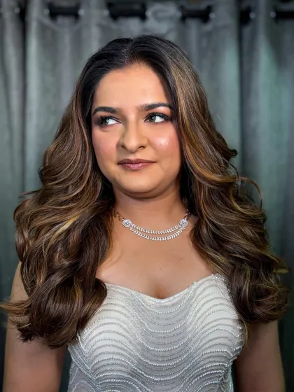 A side profile showing the beautiful highlights and volume in her hair.