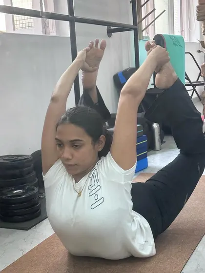 A student holding a beautiful Dhanurasana (Bow Pose) in our mentorship workshop.