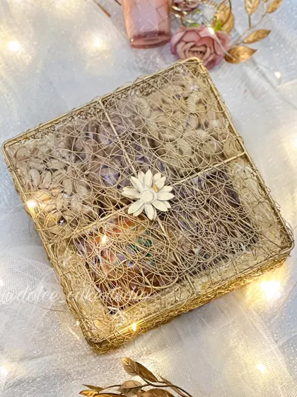 This is my square mesh box hamper for Diwali, all closed up. The golden wire mesh and simple flower detail give it a rustic yet elegant feel.