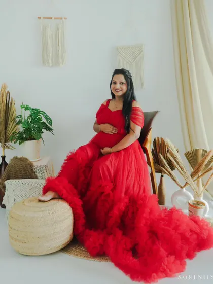 Dressed in a stunning, fiery red ruffled gown, this mother-to-be looks absolutely radiant. My studio sessions can be styled to create these glamorous, magazine-worthy portraits.