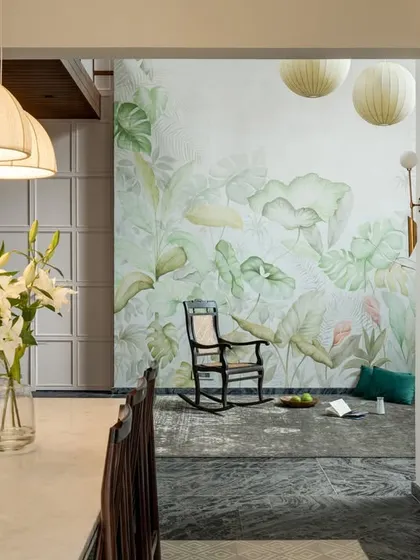 Looking from the dining area into the living room, this view highlights the open, flowing nature of the ground floor. The mural acts as a stunning backdrop, unifying the different zones of the space.