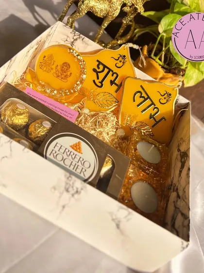 A complete Diwali hamper in auspicious yellow, including a Lakshmi Ganesh standee, Shubh Labh hangings, and tea-light holders.