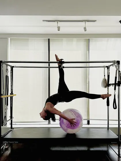 The full expression of this advanced Cadillac pose, demonstrating incredible flexibility and strength.