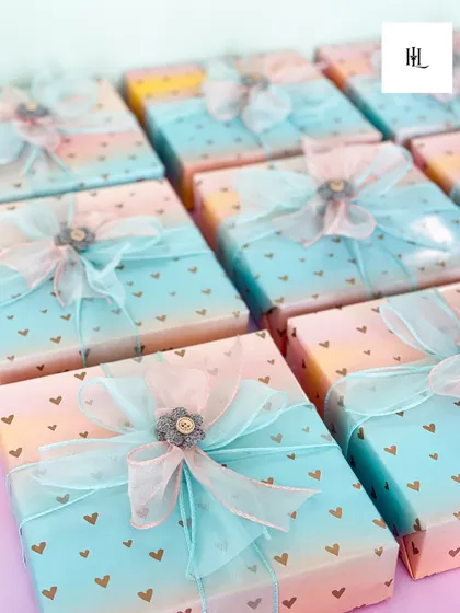 Where packaging meets perfection. These beautifully wrapped gifts with their delicate ombre paper and intricate bows show my commitment to making the unboxing experience as special as the gift itself.