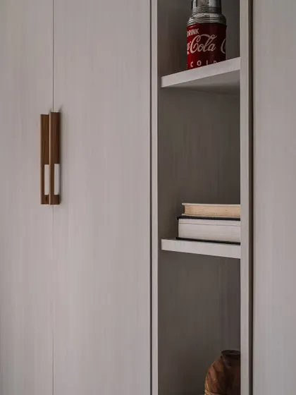 A close-up of the custom handle and shelving detail in the den, showcasing the mix of materials and attention to craftsmanship.