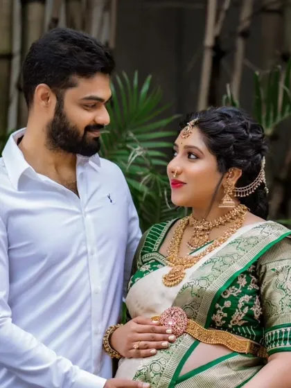 A precious moment between the expecting couple. The comfortable and elegant saree drape allows for beautiful and natural poses during their maternity shoot.